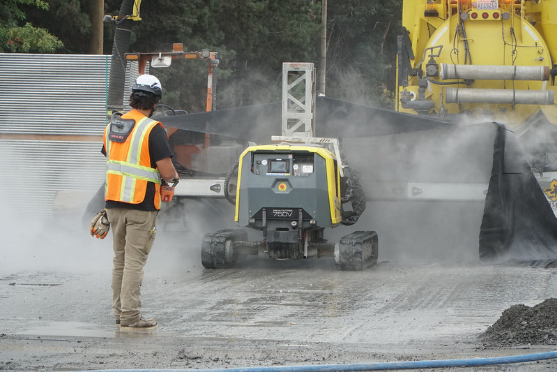 Crews performing hydroblasting work, removing access debris from the bridge deck.