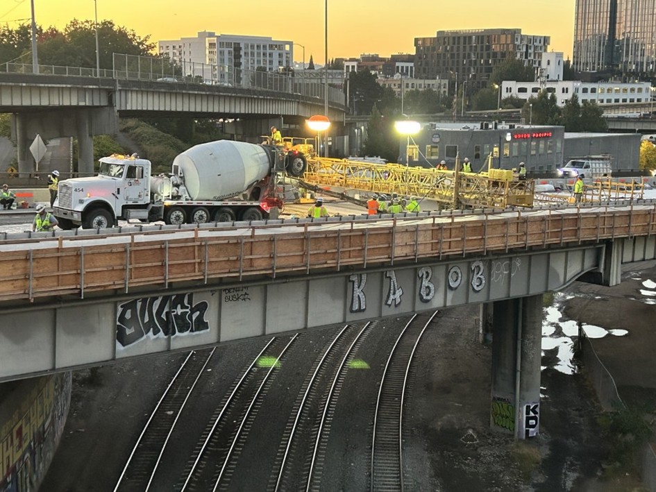 Crews and concrete equipment on the I-5 overpass.
