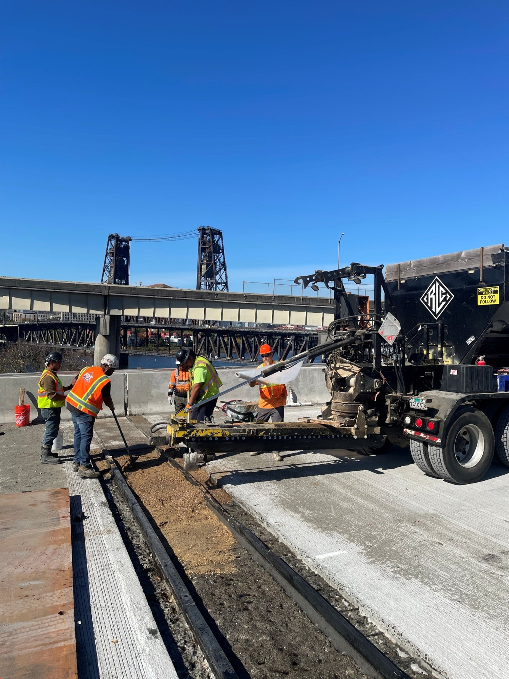 Construction crews adding protective material to the bridge’s expansion joints.