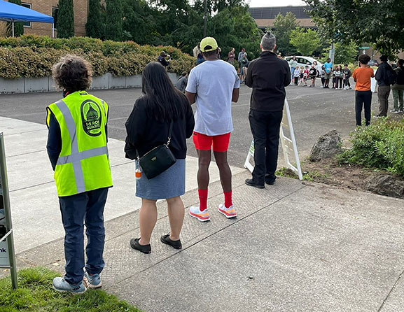 Adults line street to cheer on kids running a race